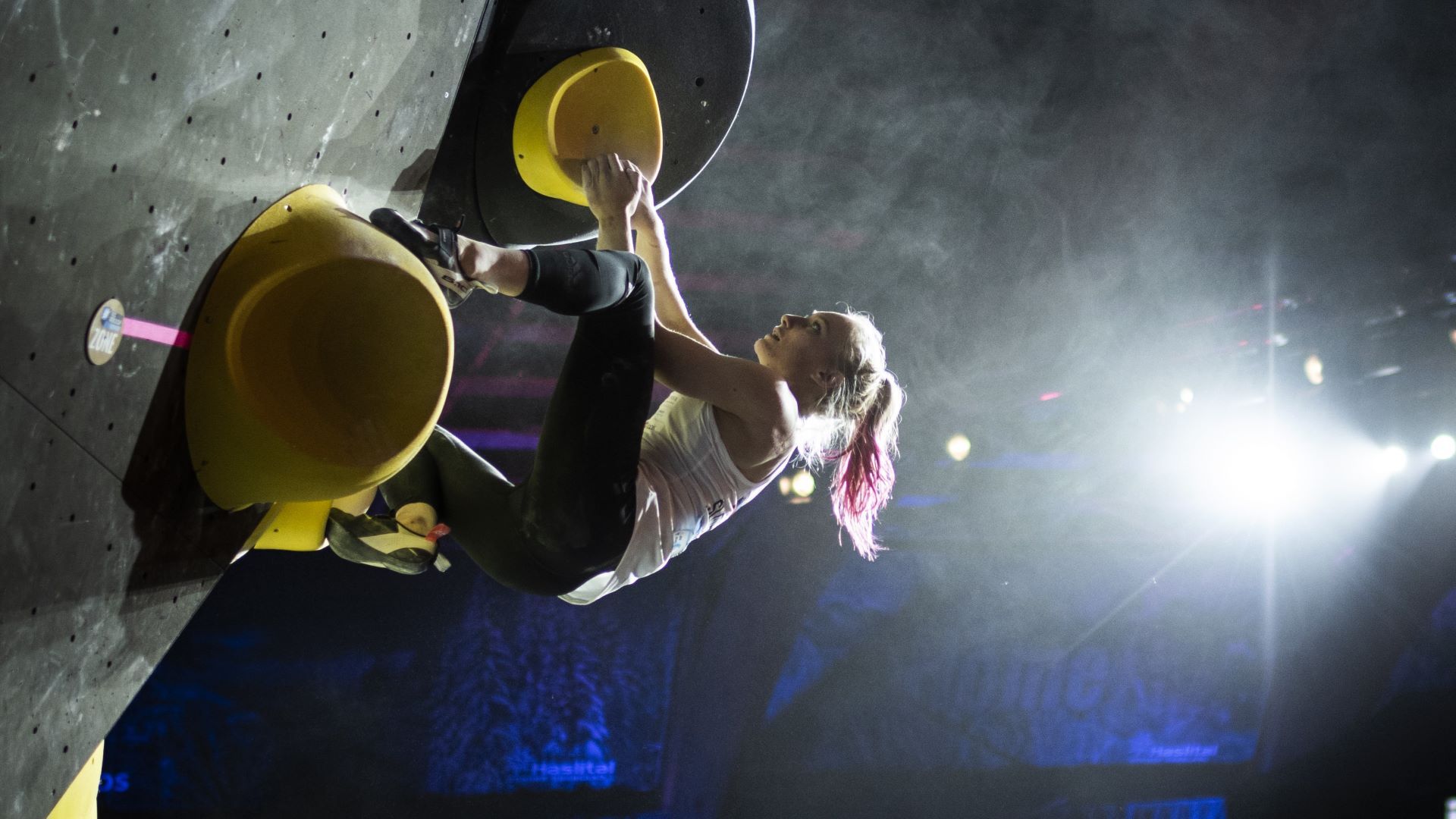 woman climbing a wall